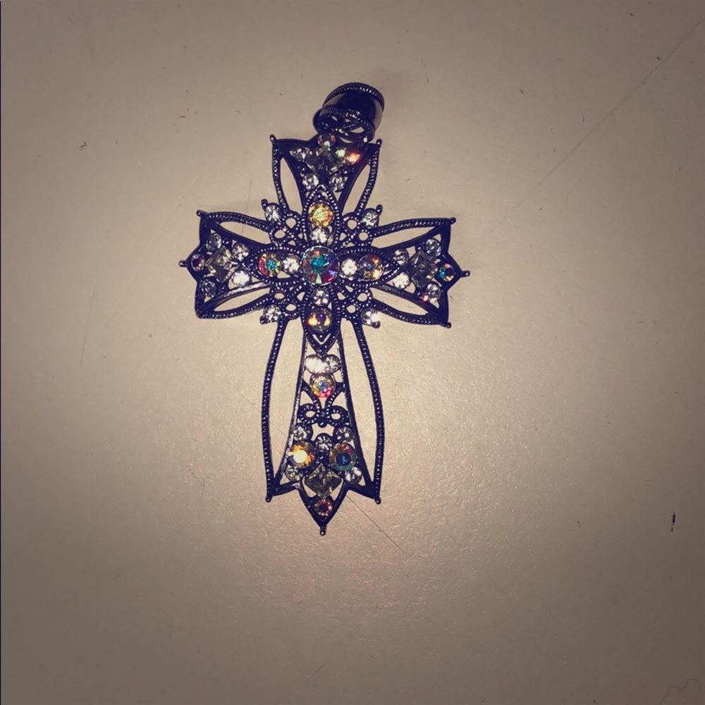 Cross charm that goes on a necklace